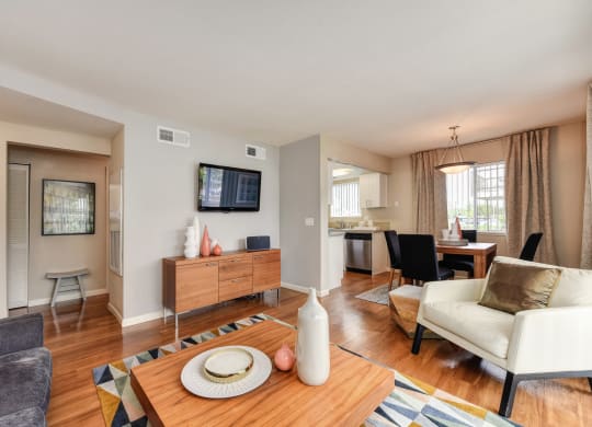 Living Room with Television with Wood Inspired Floor, White Sofa at Addison Ranch Apartments, Petaluma
