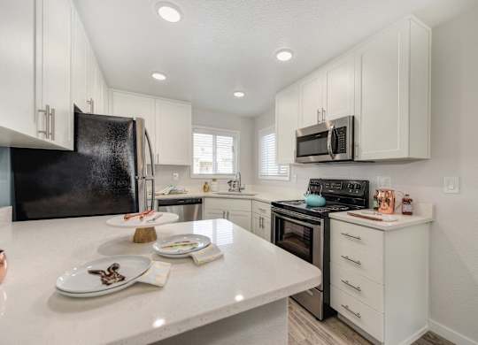 Kitchen with White Countertop at The Legacy Apartments, Antelope, California