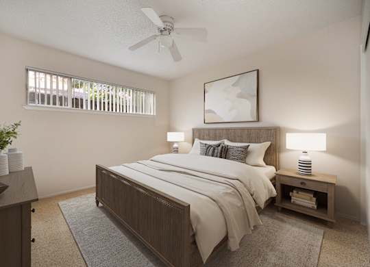 A bedroom with a bed, nightstand, and a ceiling fan.