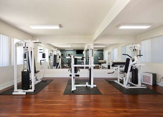a workout room with a variety of exercise equipment