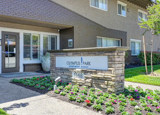 a brick building with a sign that reads owens park dental office  at Olympus Park Apartments, Roseville, CA, 95661