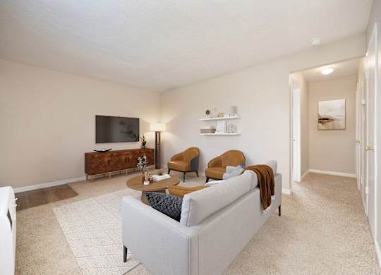 A living room with a white couch and a television.