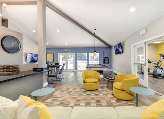 a living room with couches and chairs and a ping pong table at Renaissance Park Apartments, Davis, CA, 95618