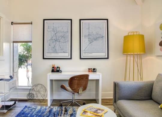 a home office with a white desk and a yellow lamp at Renaissance Park Apartments, Davis, CA