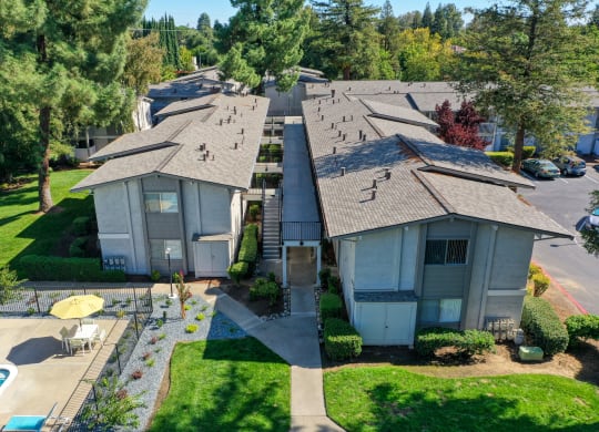 Ariel shot above the community overlooking the buildings, walk paths and community swimming pool. at Renaissance Park Apartments, California, 95618