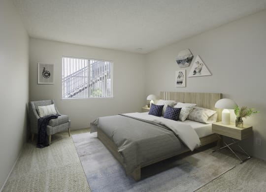 a bedroom with a bed and a chair and a window at Renaissance Park Apartments, California