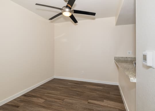 One Bedroom Dining Room with a ceiling fan and bar style counter top at Rocklin Manor  Apartments, California