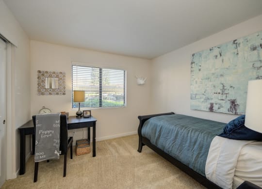 Model Bedroom with twin size bed and work from home desk under the bedroom window at Rocklin Manor  Apartments, California, 95677