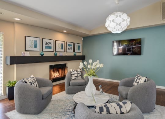Leasing Office sitting area with flat screen tv on the call and fireplace with black mantle at Rocklin Manor  Apartments, California, 95677
