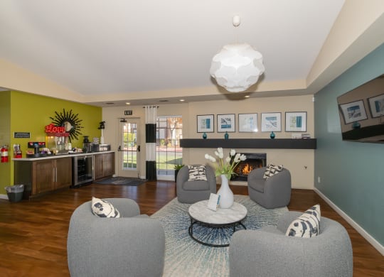 a living room with couches and chairs and a fireplace at Rocklin Manor  Apartments, California