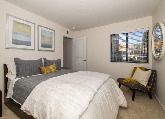 a bedroom with a large bed and a window at Rocklin Manor  Apartments, Rocklin  , CA
