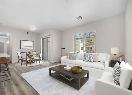 a living room with white couches and a coffee table