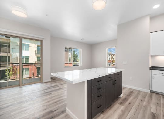 an open kitchen with white countertops and a large island
