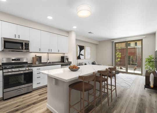 a kitchen with white cabinets and a large island with a white countertop