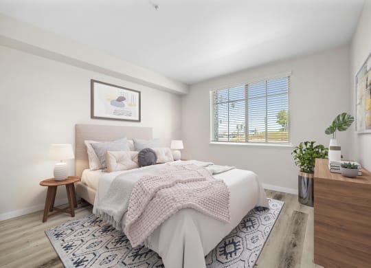 a bedroom with a large bed and a large window