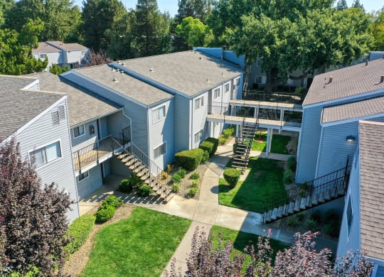 an aerial view of a row of houses with trees in the background at Silverstone Apartments, Davis, CA