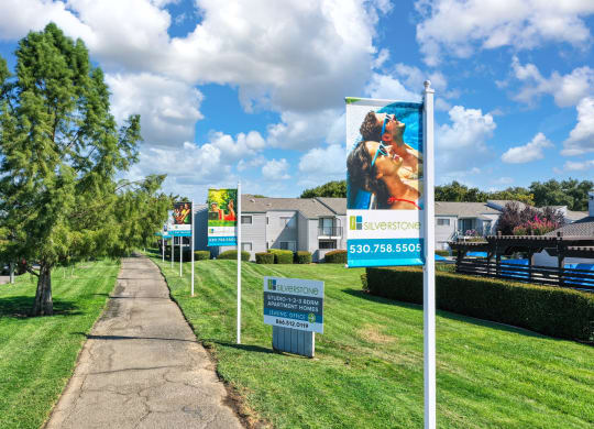 a row of signs in front of houses at Silverstone Apartments, Davis ,95618