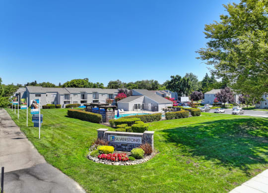 a view of a neighborhood with houses and a sign in the grass at Silverstone Apartments, Davis, CA, 95618
