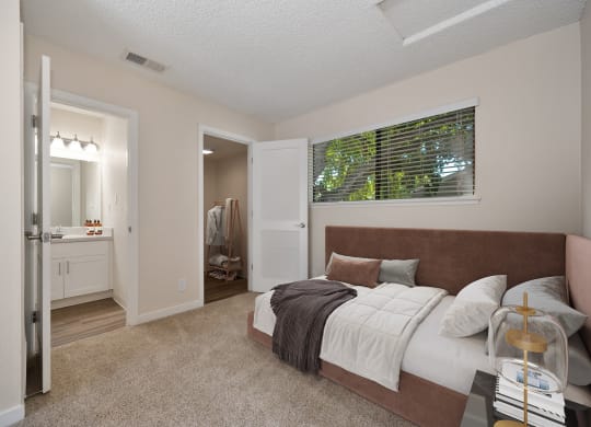 a bedroom with a large bed and a bathroom with a shower at Silverstone Apartments, California