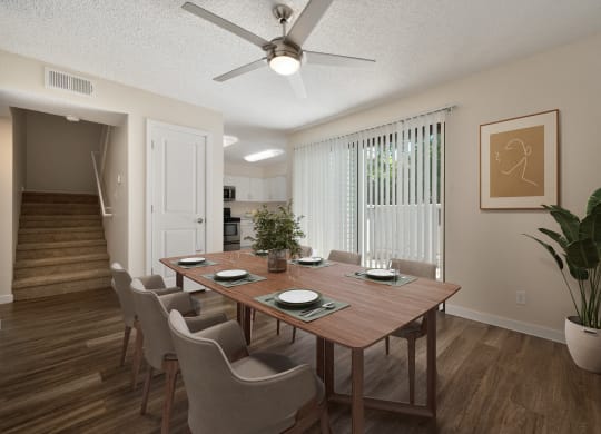 a dining room with a table and chairs and a ceiling fan in the townhome floorplan at Silverstone Apartments, Davis, California