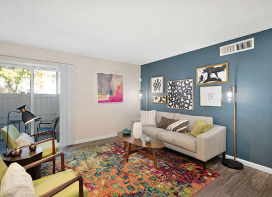 a living room with a couch and a chair and a window