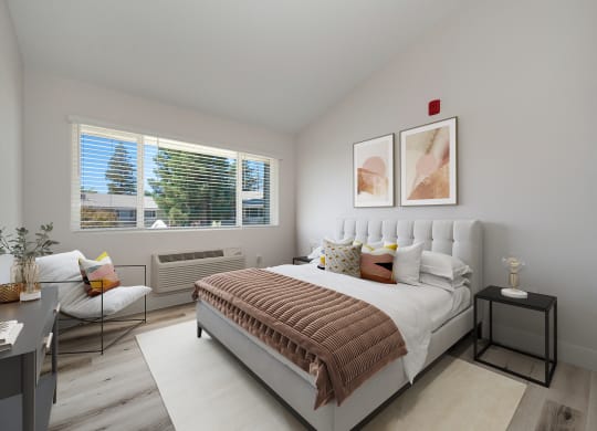 a bedroom with a bed and two windows  at Track 281 Apartments, Sacramento, CA, 95811