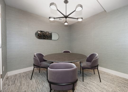 a meeting room with a table and chairs and a chandelier  at Track 281 Apartments, California, 95811