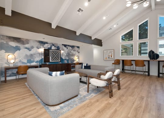 a living room with couches and chairs and a wall mural  at Track 281 Apartments, Sacramento, CA, 95811