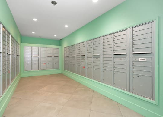 a bunch of lockers in a room with green walls  at Track 281 Apartments, Sacramento, CA