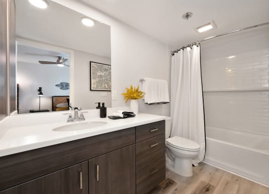 a bathroom with a sink and a shower and a toilet  at Track 281 Apartments, California, 95811