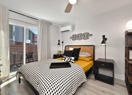 a bedroom with a bed and a large window  at Track 281 Apartments, California, 95811