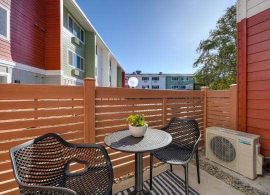 a patio with two chairs and a table on a balcony  at Track 281 Apartments, Sacramento, 95811