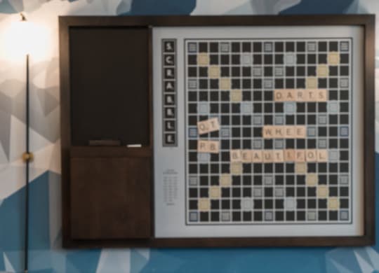 a chess board on a table in a room with a tv