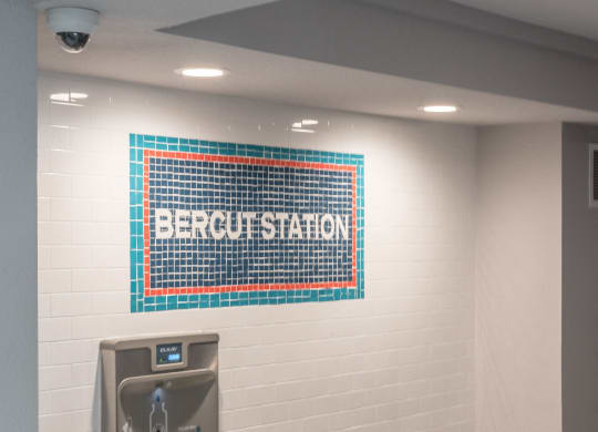 a public restroom with a urinal and a sink and a bench