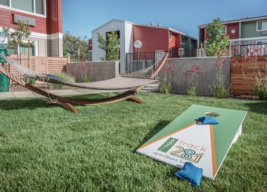a yard with a hammock and a sign in the grass