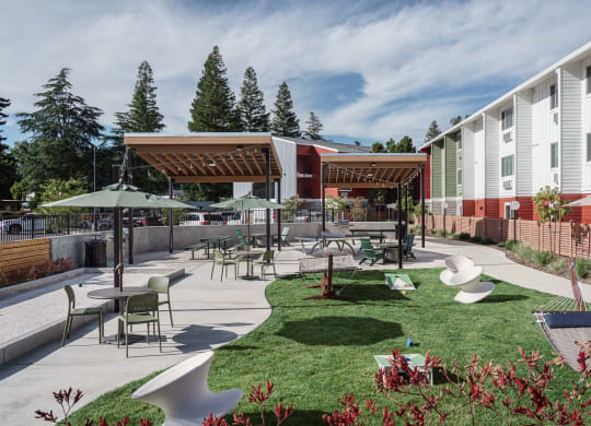 a courtyard with tables and chairs and umbrellas