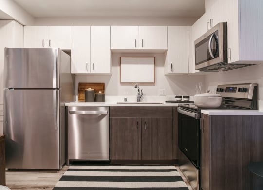 a kitchen with stainless steel appliances and white cabinets