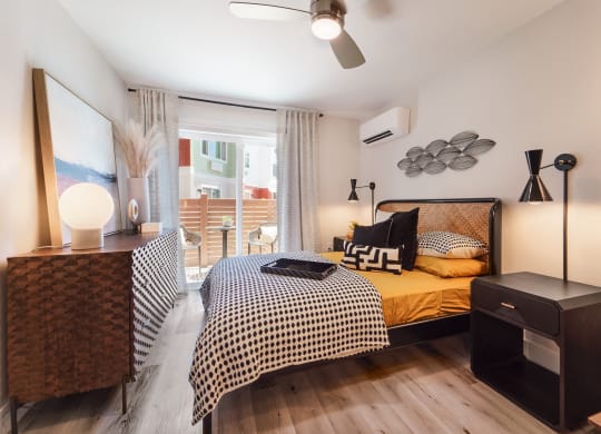 a bedroom with a bed and a large window