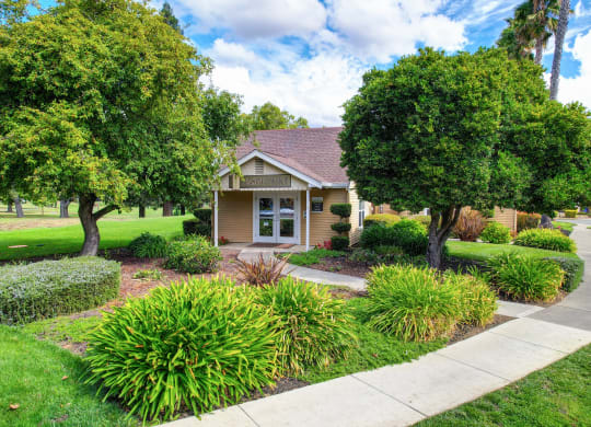 Building Exterior and Leasing Office entrance with green landscaping, Bushes and Trees at Vineyard Terrace Apartments, Napa, CA