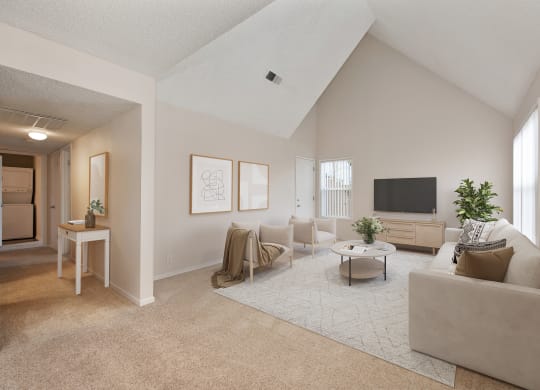 the living room of an apartment with a couch and a tv at Vineyard Terrace Apartments, Napa, CA