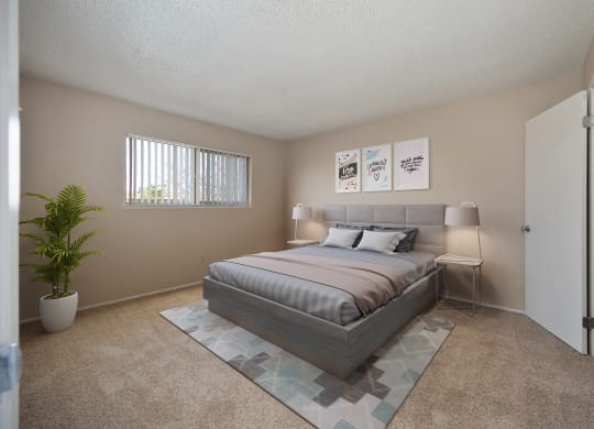 a bedroom with a bed and a potted plant