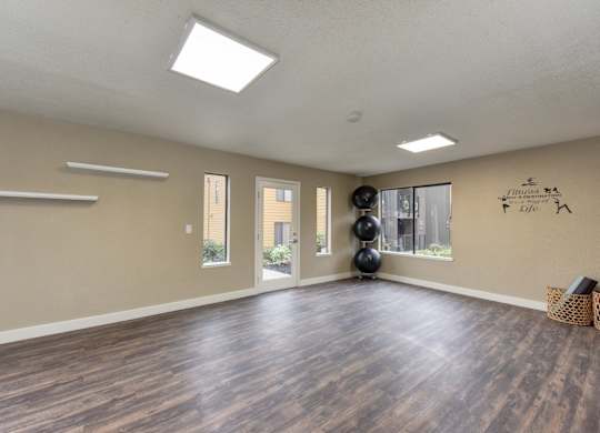 Community Yoga Studio with Hardwood Inspired Floor, Yoga Balls, Large Window and Wicker Basket with Yoga Mats at Fountains of Fair Oaks, Fair Oaks, CA 95628