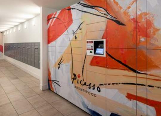 A large mural of a woman's face is painted on a wall.