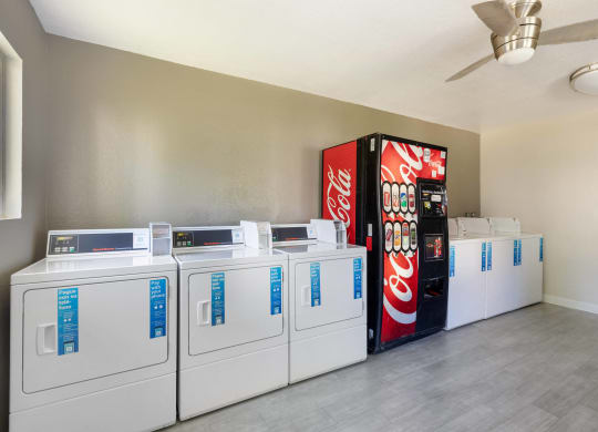 a laundromat with vending machines and a coke machine