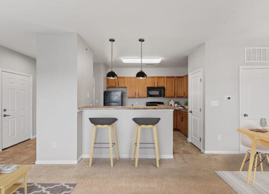 Kitchen with a breakfast bar at Aspen Lakes Apartments, Indiana