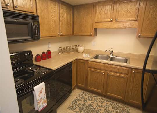 Kitchen with All New Black Appliances at Woodland Springs Apartment Homes, Carmel, 46033