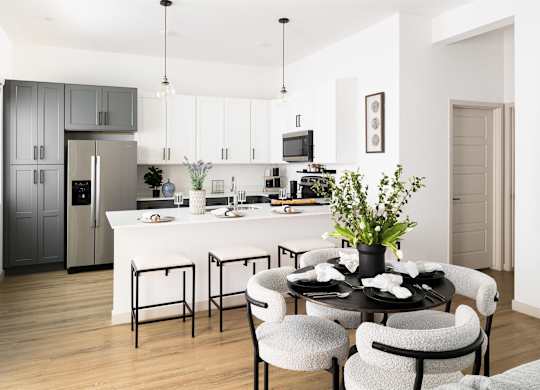 a living room and kitchen with a table and chairs at Villas on Ash, Gilbert, 85234
