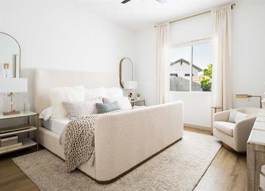 a bedroom with a bed and a couch and a window at Villas on Ash, Gilbert, AZ