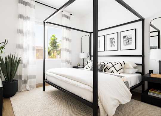 a bedroom with a bed and a black canopy bed at Villas on Ash, Gilbert, AZ