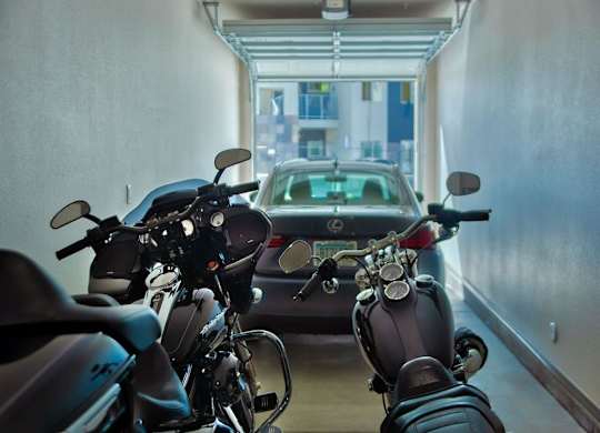 apartment garage showing two motorcycles in the foreground and Carat Craft at Gilbert and Baseline, Mesa, 85204